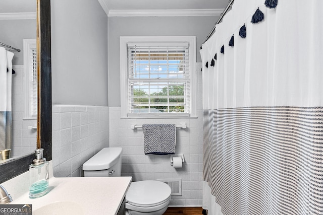 bathroom with crown molding, tile walls, vanity, and toilet