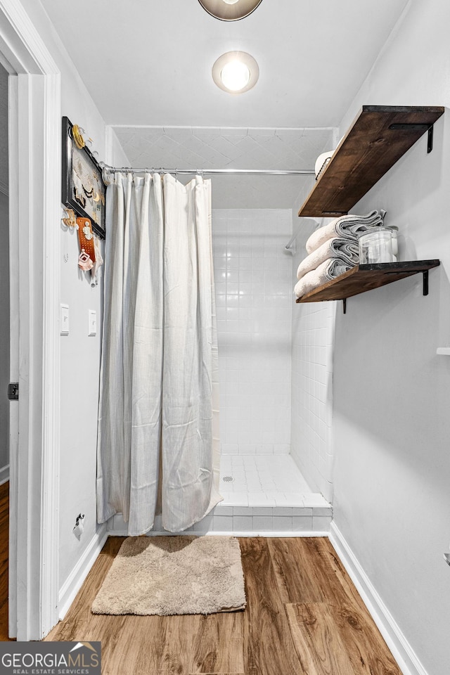 bathroom with hardwood / wood-style floors and curtained shower