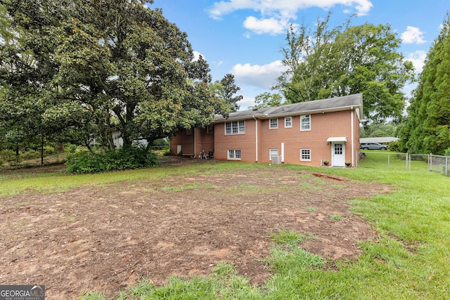 rear view of property with a yard