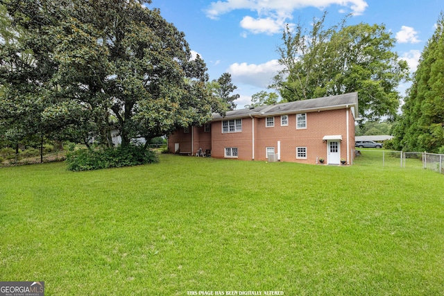 back of house featuring a yard