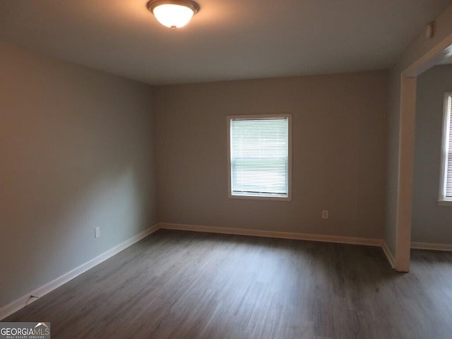 spare room featuring dark wood-type flooring