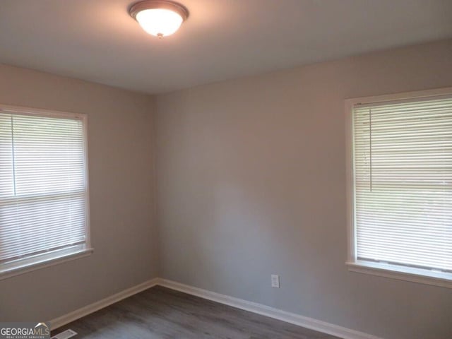 spare room featuring dark hardwood / wood-style flooring