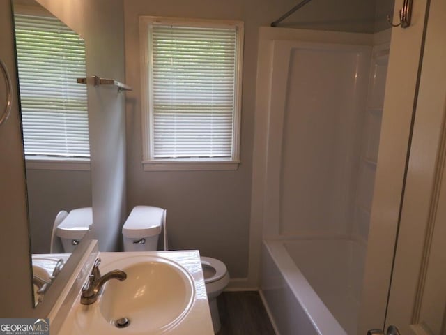 full bathroom featuring sink, a wealth of natural light, shower / washtub combination, and toilet