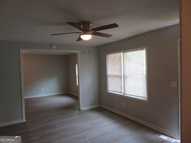 spare room featuring hardwood / wood-style flooring and ceiling fan