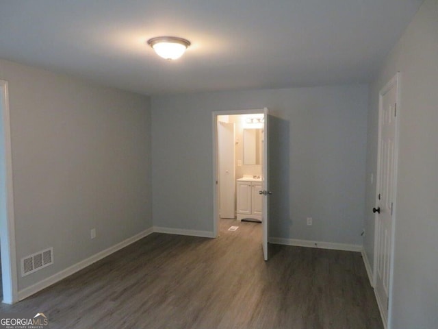 empty room featuring dark hardwood / wood-style flooring