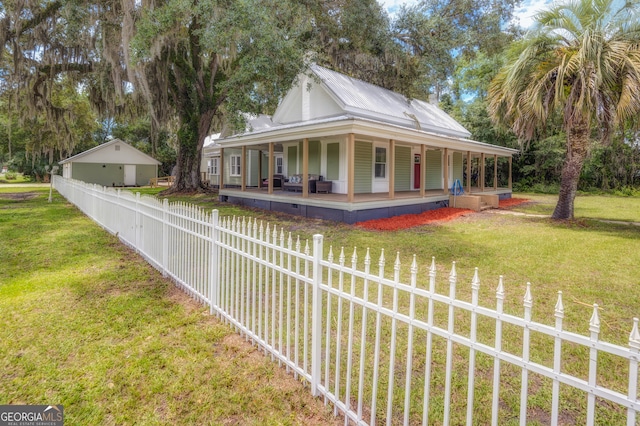 exterior space featuring covered porch and a yard