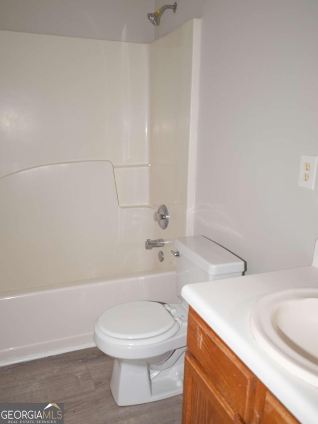 full bathroom with vanity, toilet, bathing tub / shower combination, and hardwood / wood-style flooring