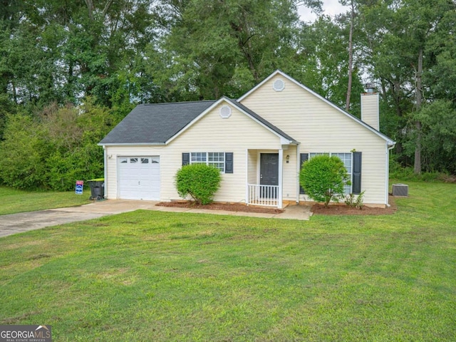15 Marissa Cv, Riverdale, GA 30274 - view of front of property featuring concrete driveway, a chimney, a garage, a front lawn, and view of wooded area