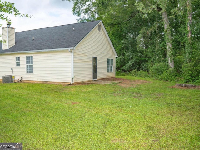15 Marissa Cv, Riverdale, GA 30274 - view of home's exterior featuring a yard, a chimney, and a shingled roof