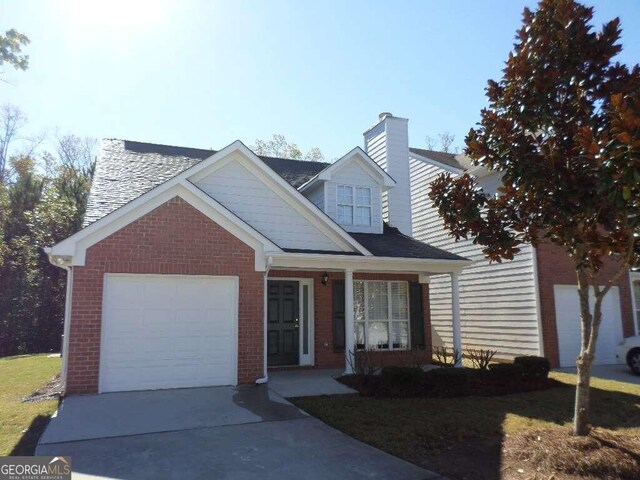 view of front of property with a porch and a garage