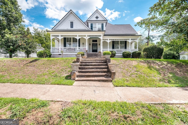 victorian-style house featuring covered porch