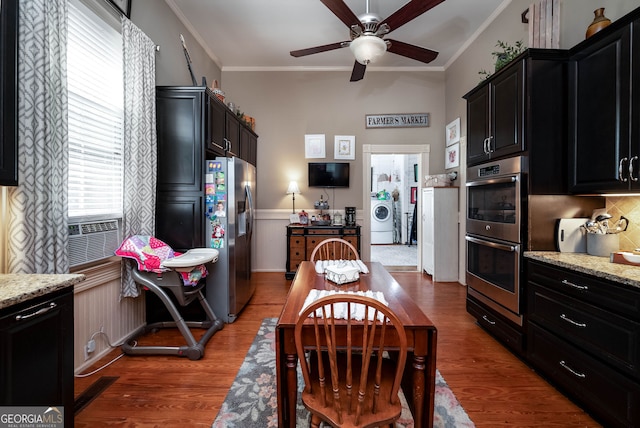 kitchen featuring wood-type flooring, crown molding, and appliances with stainless steel finishes