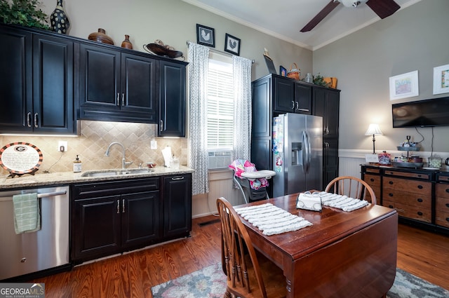 kitchen with ceiling fan, dark hardwood / wood-style flooring, crown molding, sink, and appliances with stainless steel finishes