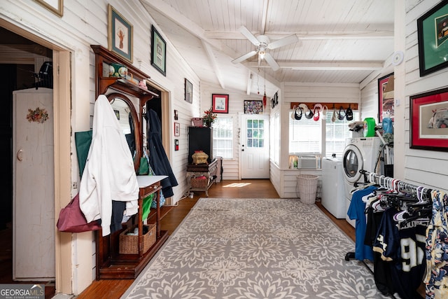 mudroom with separate washer and dryer, wood-type flooring, and vaulted ceiling with beams