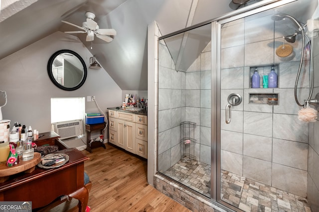 bathroom with vaulted ceiling, hardwood / wood-style floors, an enclosed shower, and ceiling fan