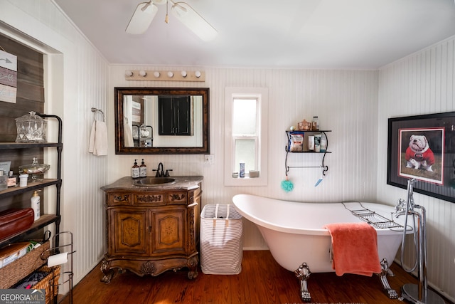 bathroom with vanity, ceiling fan, hardwood / wood-style floors, and a bathtub