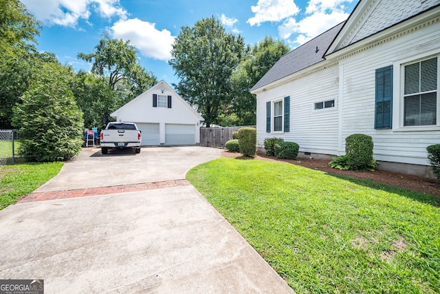 view of yard with a garage and an outdoor structure