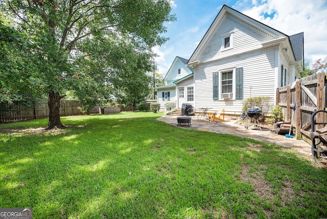 back of house featuring a yard, a patio area, and cooling unit