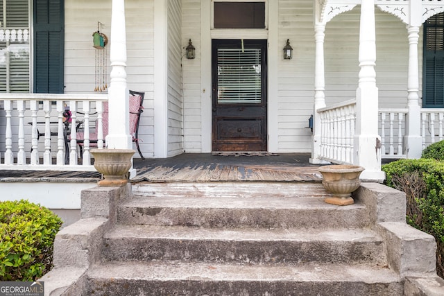 view of exterior entry with covered porch