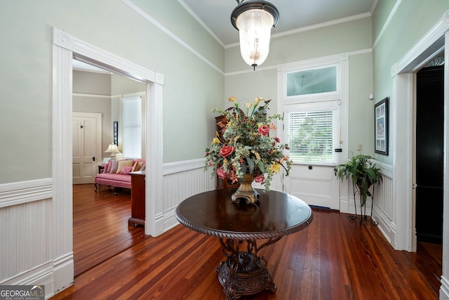 hallway with hardwood / wood-style flooring and crown molding