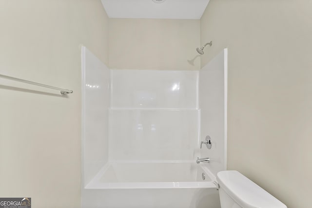 bathroom with shower / washtub combination and toilet