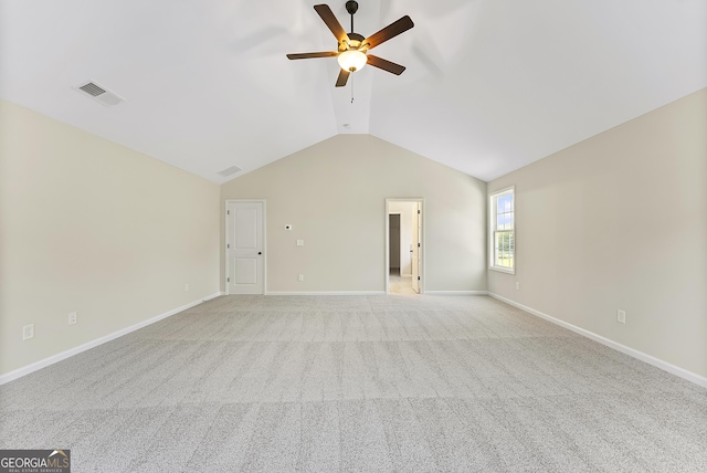 spare room with light carpet, vaulted ceiling, and ceiling fan