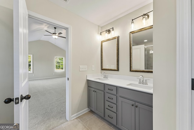 bathroom featuring tile patterned floors, ceiling fan, vanity, and lofted ceiling