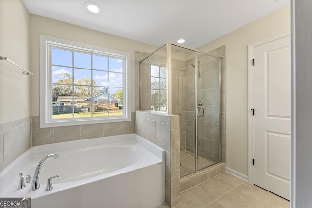 bathroom featuring tile patterned flooring and plus walk in shower