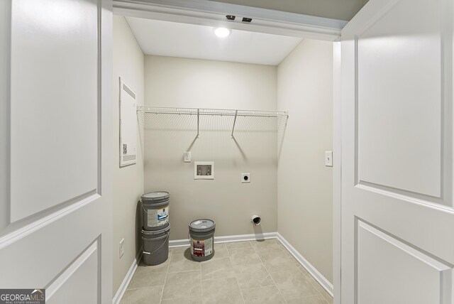 clothes washing area featuring hookup for an electric dryer, light tile patterned floors, and hookup for a washing machine