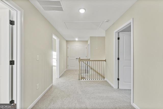 hall with light colored carpet