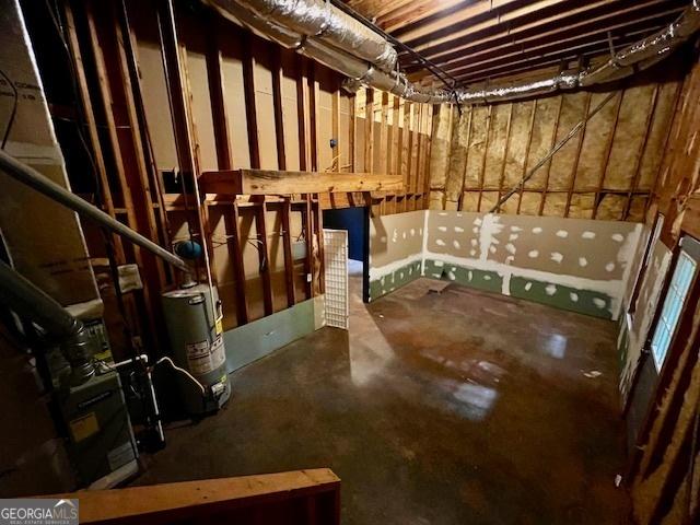 basement featuring water heater and a jacuzzi