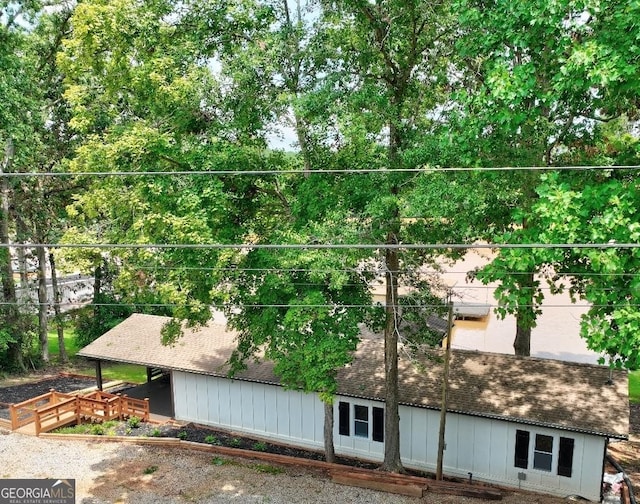 exterior space featuring a shingled roof