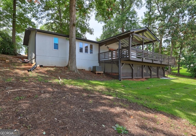 rear view of property with a deck, a lawn, and central air condition unit