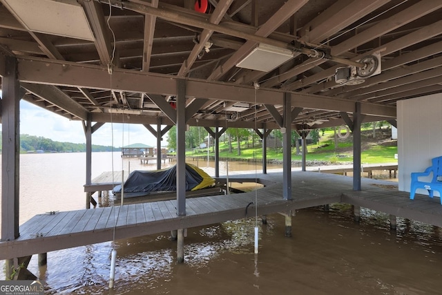 dock area with a water view and boat lift