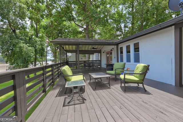 wooden terrace with an outdoor hangout area and french doors