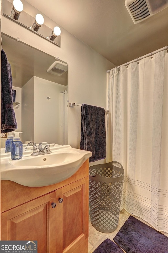 full bathroom featuring tile patterned flooring, vanity, and visible vents