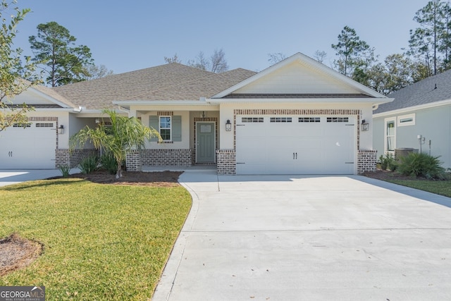 view of front of house with a garage and a front yard