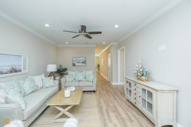 living room with light hardwood / wood-style floors, ornamental molding, and ceiling fan