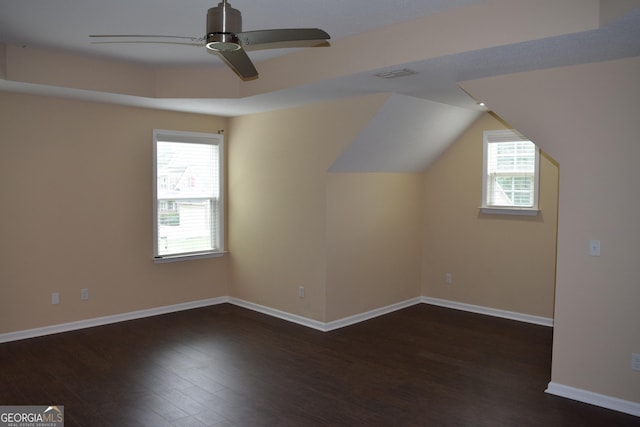 bonus room with ceiling fan, vaulted ceiling, dark hardwood / wood-style floors, and a healthy amount of sunlight