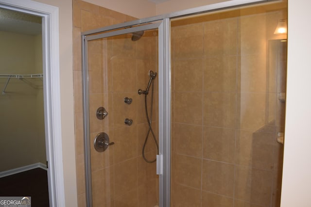 bathroom featuring a shower with door