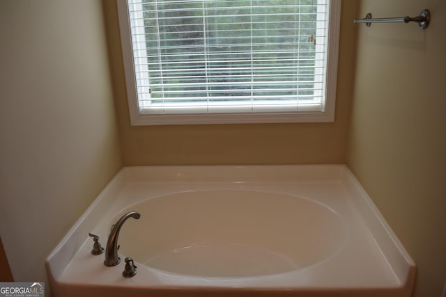 bathroom with a wealth of natural light and a tub to relax in