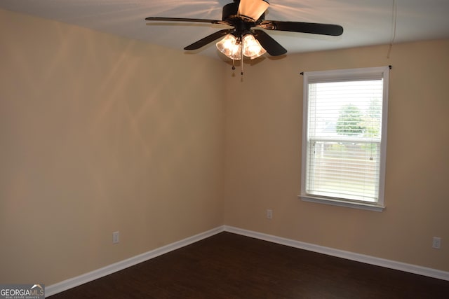 unfurnished room with ceiling fan and dark hardwood / wood-style floors