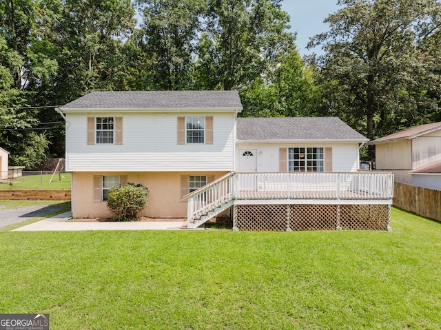 view of front of house with a wooden deck and a front lawn