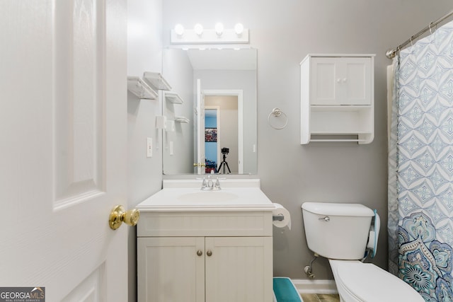 bathroom featuring toilet and vanity