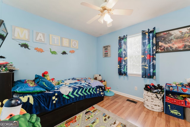 bedroom with wood-type flooring and ceiling fan