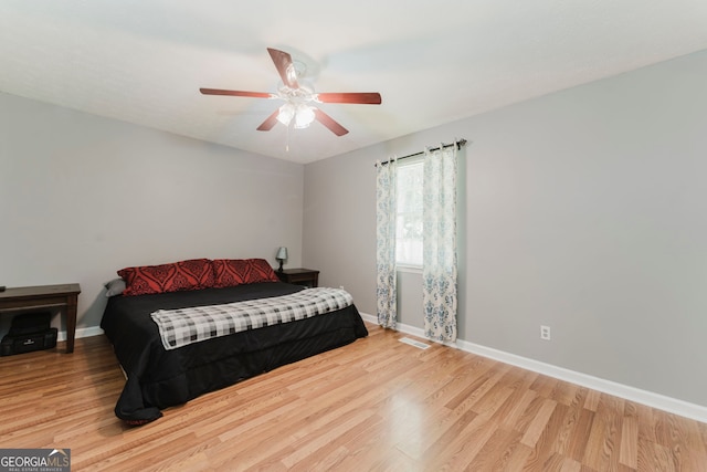 bedroom with ceiling fan and light hardwood / wood-style floors