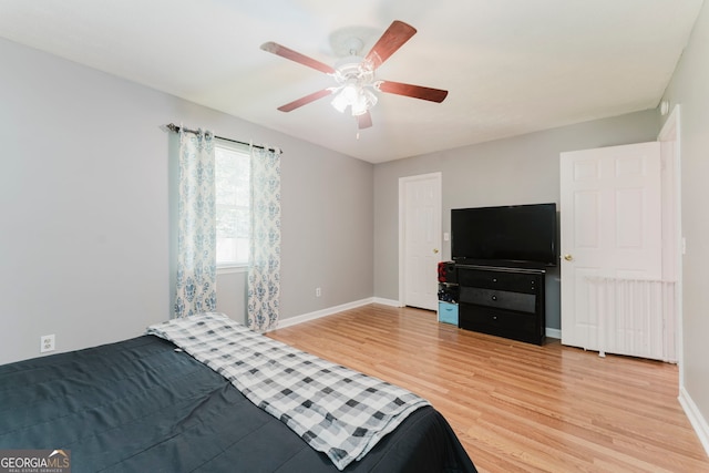 bedroom featuring light hardwood / wood-style floors and ceiling fan