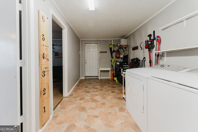 clothes washing area with washer and clothes dryer and light tile patterned floors