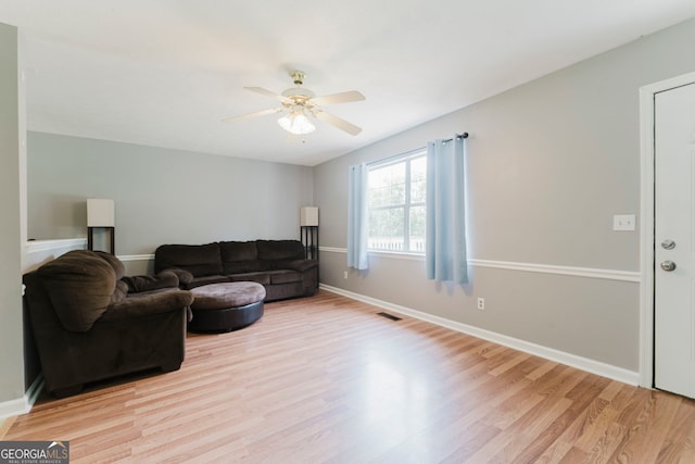 living room with ceiling fan and light hardwood / wood-style floors