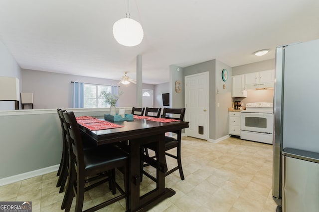 dining space featuring light tile patterned flooring and ceiling fan